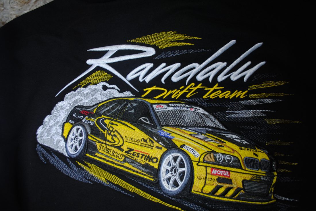 Embroidered drift-car design on black