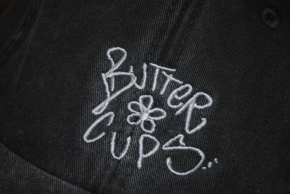 BUTTERCUPS embroidered lettering on a cap